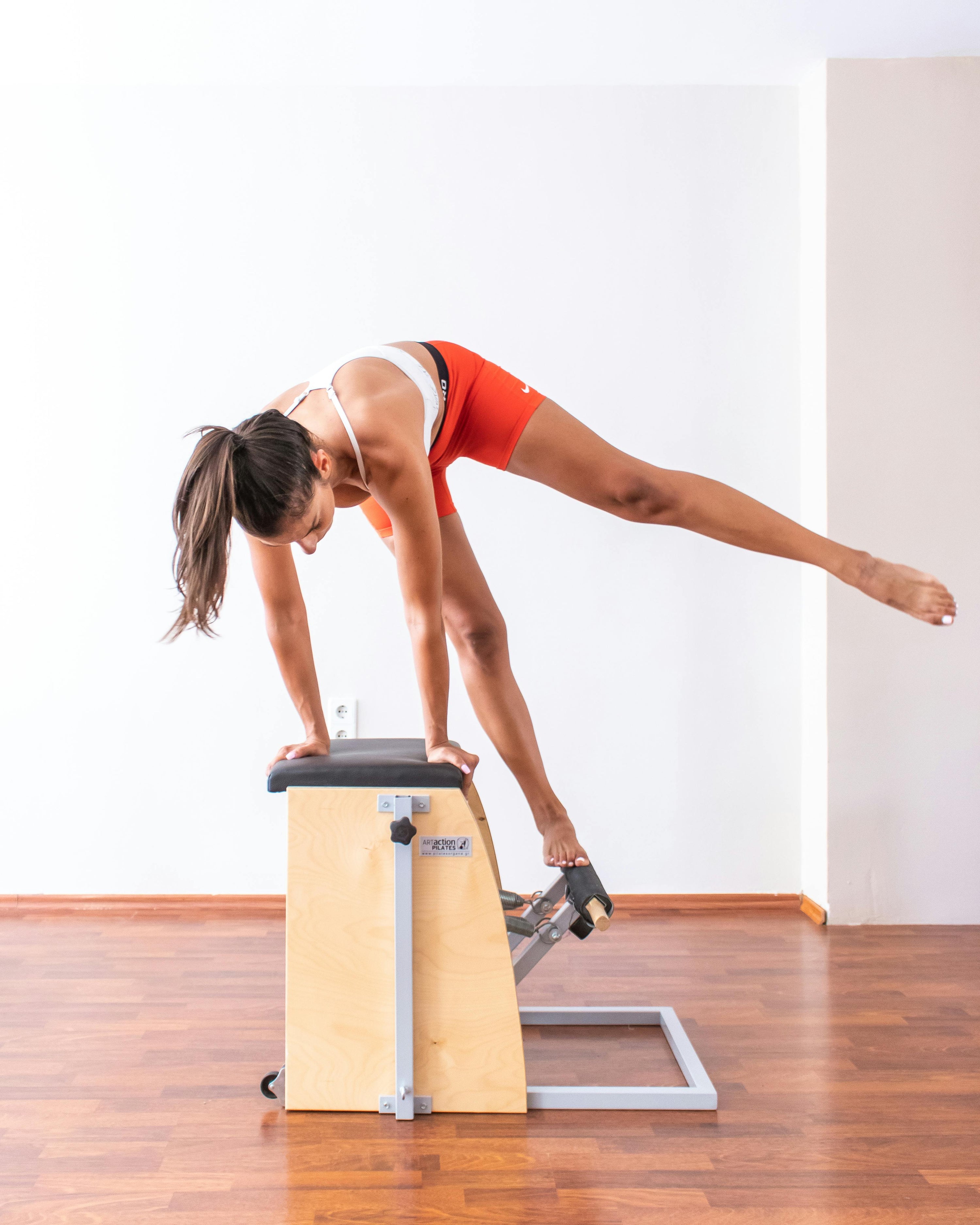 A woman exercising on a Wunda Chair